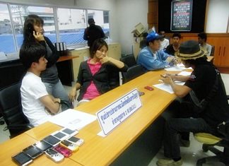 Chatchai Yaikrathok (seated, left) and Amporn Kongkaew (seated, 2nd left) were caught up in the latest police raid on Tukcom Pattaya.